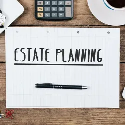 A notebook on a desk that says Estate Planning